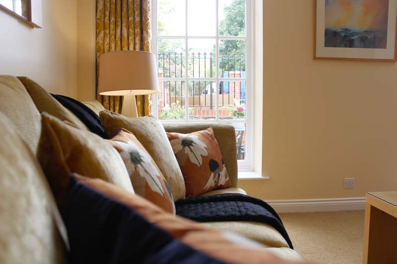 A comfy sofa in the living area of one of our business apartments